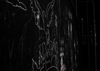 a black wall with white writing on it