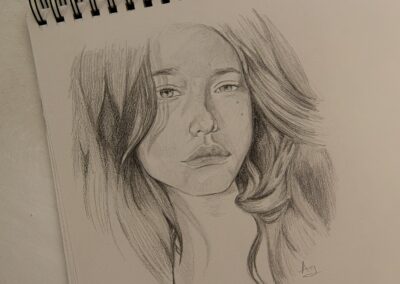 womans face sketch on white paper